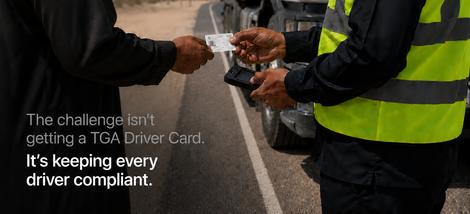 Roadside inspector checking a heavy vehicle driver's TGA Driver Card beside a truck on a Saudi highway