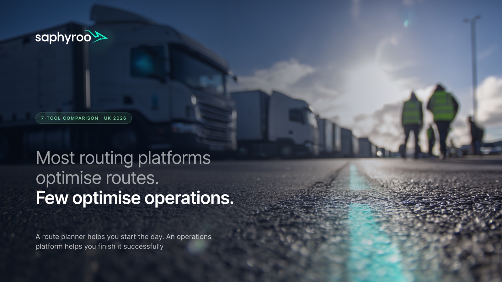 Lorries lined up at a depot at dawn with a glowing route line on the road. Saphyroo route planner comparison, UK 2026.